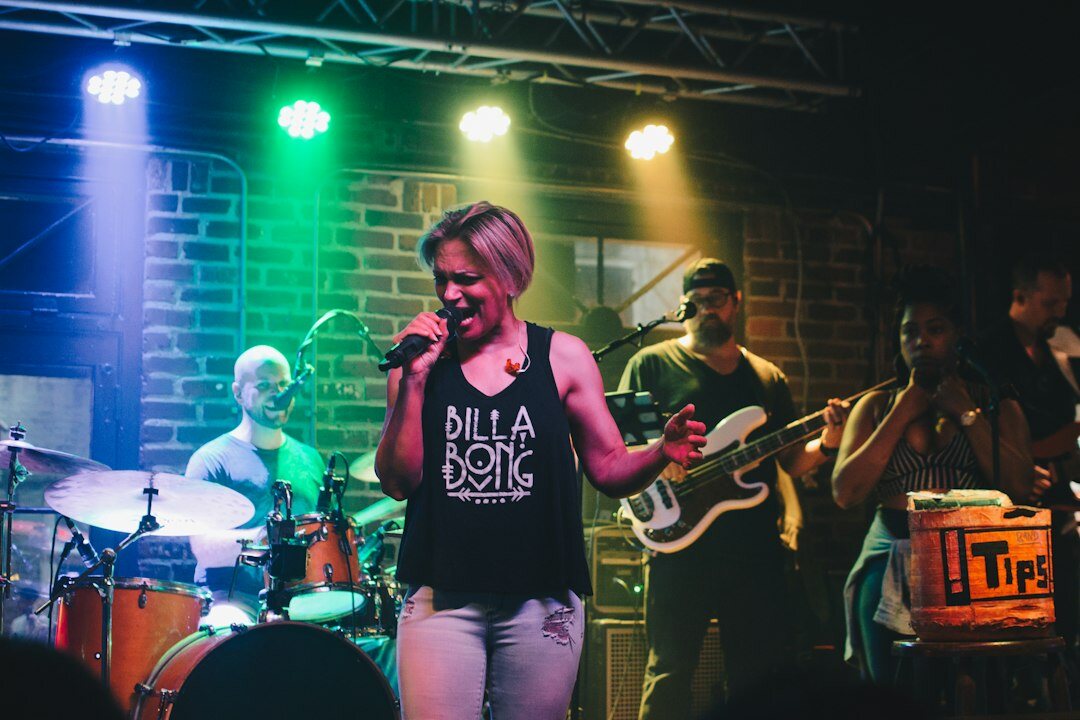 Uruguayan singer performing on stage with colorful lights