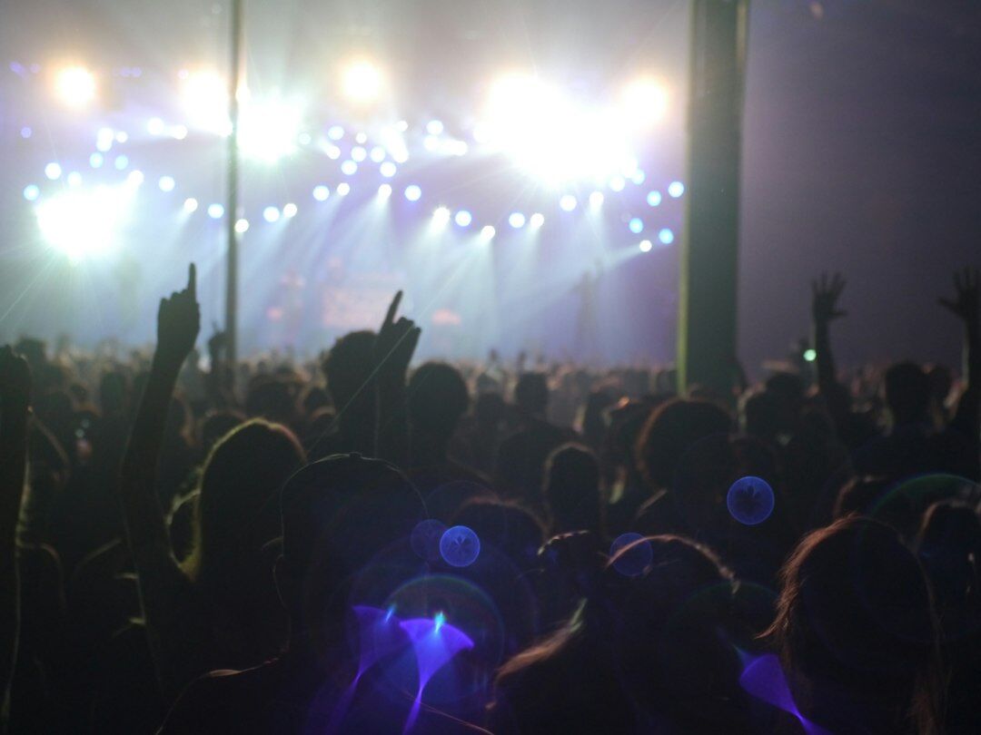 Crowd enjoying a live concert with stage lights